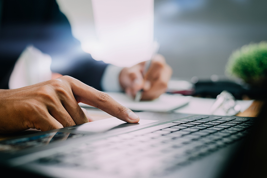 closeup of person's pointer finger on computer mousepad