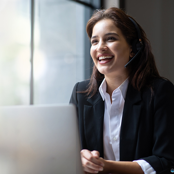 business women, smiling, with a headset on