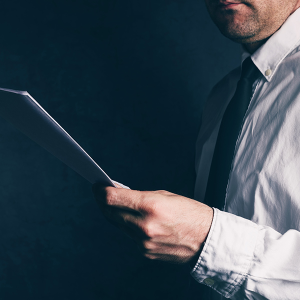 closeup of business man holding a stack of papers